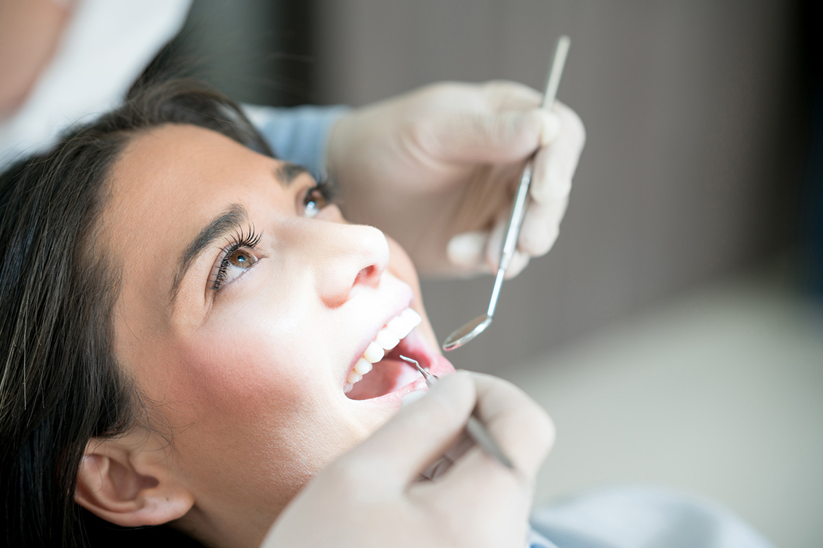 a lady is having dental cleaning treatment
